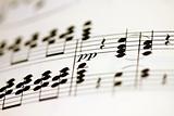 Music notes, printed on paper, macro close up with shallow depth
