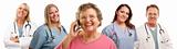 Happy Senior Woman Using Cell Phone with Male and Female Doctors or Nurses Behind Isolated on a White Background.