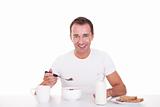 handsome man taking breakfast, isolated on white, studio shot