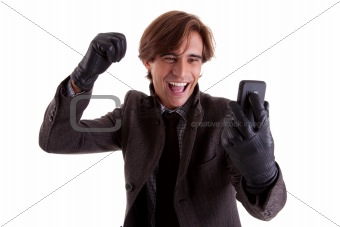 Portrait of a young happy businessman looking to the phone, in autumn/winter clothes, isolated on white. Studio shot