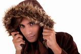 Portrait of a young man with a furry hood , in autumn/winter clothes, isolated on white. Studio shot