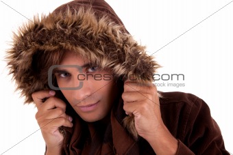 Portrait of a young man with a furry hood , in autumn/winter clothes, isolated on white. Studio shot