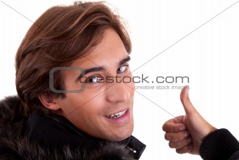 Portrait from back of a young man with thumb up, in autumn/winter clothes, isolated on white. Studio shot