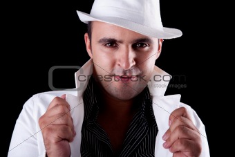 Portrait of a man with his white hat and coat, isolated on black. Studio shot