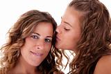 Happy daughter kissing mother, isolated on white. Studio shot