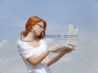 Young Businesswomen in white keeping laptop