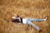 Young beautiful girl lying at yellow autumn field.