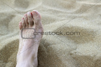 man foot in summer beach sand