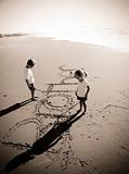 Kids writing in sand