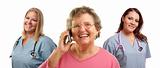 Happy Senior Woman Using Cell Phone with Female Doctors or Nurses Behind Isolated on a White Background.