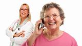 Happy Senior Woman Using Cell Phone with Female Doctor or Nurse Behind Isolated on a White Background..