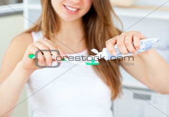 Close-up of a beautiful caucasian woman holding a toothbrush in the bathroom