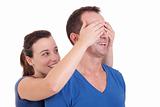 Portrait of a happy woman covering his man eyes, to surprise him