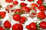 Strawberries splashing in water