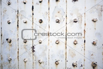 Rusty metal wall with bolts
