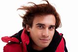 Portrait of a young man with hair on the wind , in autumn/winter clothes, isolated on white. Studio shot