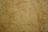 Honey colored cracked plaster wall 