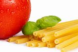 raw macaroni with tomato and basil closeup