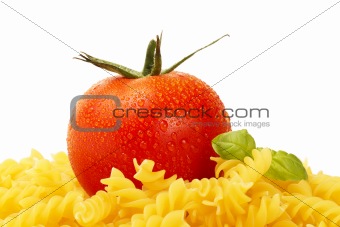 some raw fusilli with tomato and basil