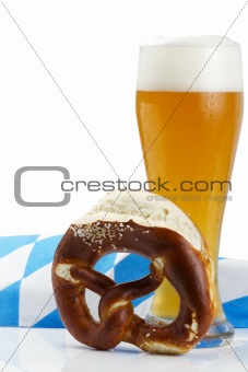 wheat beer with bavarian towel and pretzel