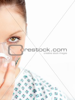 Close-upf of ill woman with a mask looking at the camera