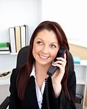 Attractive businesswoman talking on phone sitting