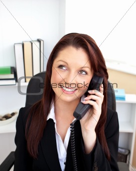 Attractive businesswoman talking on phone sitting