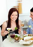 Smiling young couple dining in the kitchen
