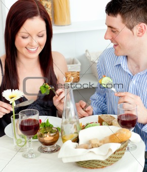 Young caucasian couple having dinner at home