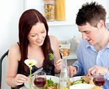 Affectionate caucasian couple having dinner at home
