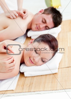 Positive young couple receiving a back massage