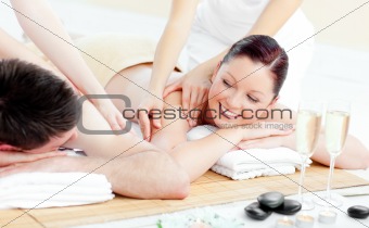 Positive young couple enjoying a back massage