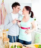 Enamored couple drinking wine in the kitchen