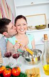 Delighted young couple cooking spaghetti in the kitchen