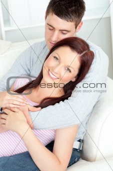 Resting young couple lying together on the sofa