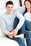 Nice boyfriend massaging his girlfriend's feet on the sofa