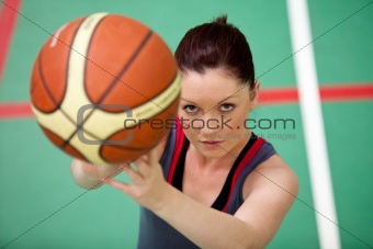 Portrait of an athletic young woman playing basket-ball