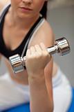Portrait of a cute woman working out with dumbbells