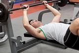 Strong man working out with dumbbells
