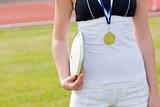 Close-up of a female athlete holding a disc preparing for throwi