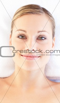 Portrait of a relaxed young woman lying on a massage table