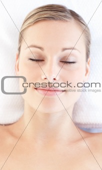 Portrait of a relaxed young woman lying on a massage table
