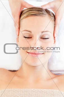 Young relaxed woman receiving a head massage