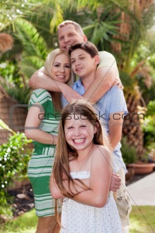 Portrait of happy family hugging each other