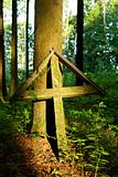 old wooden cross in a forest