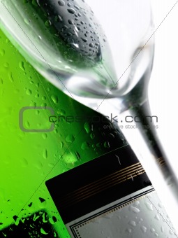 Bottle of alcoholic drink with glass