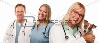 Attractive Female and Male Veterinarian Doctors with Small Puppy Isolated on a White Background.