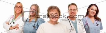 Smiling Senior Woman with Medical Doctors and Nurses Behind Isolated on a White Background.