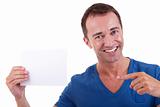 Portrait of a handsome man, with blank  card in hand, smiling, isolated on white background. Studio shot.