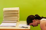 woman has stress because of huge work on her desk